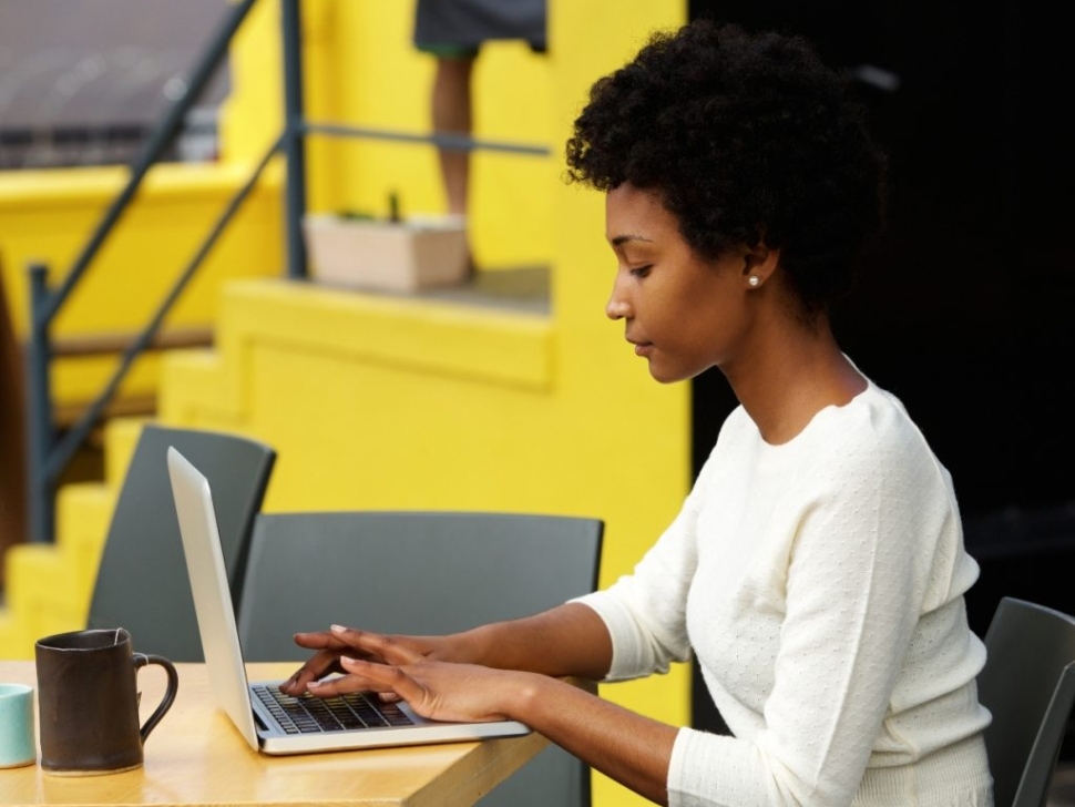 attractive-young-woman-using-laptop-outside-P9RLFGU-Jim-Fahad-Digital